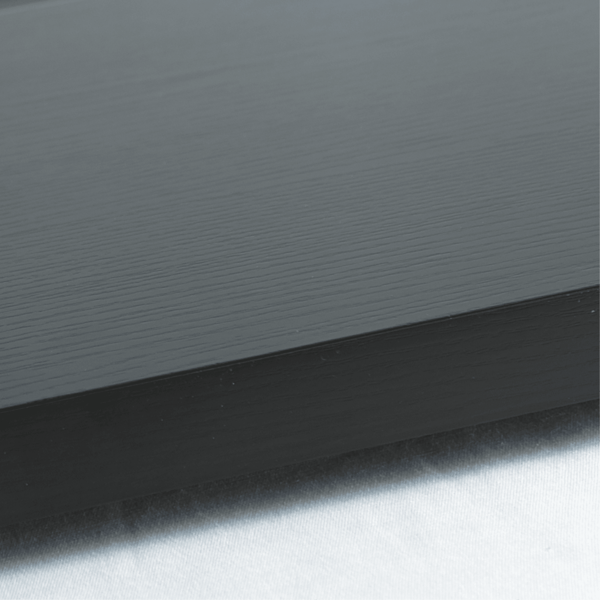 Black woodgrain textured base with smooth one-tier flat glass cover for ambient cake display.