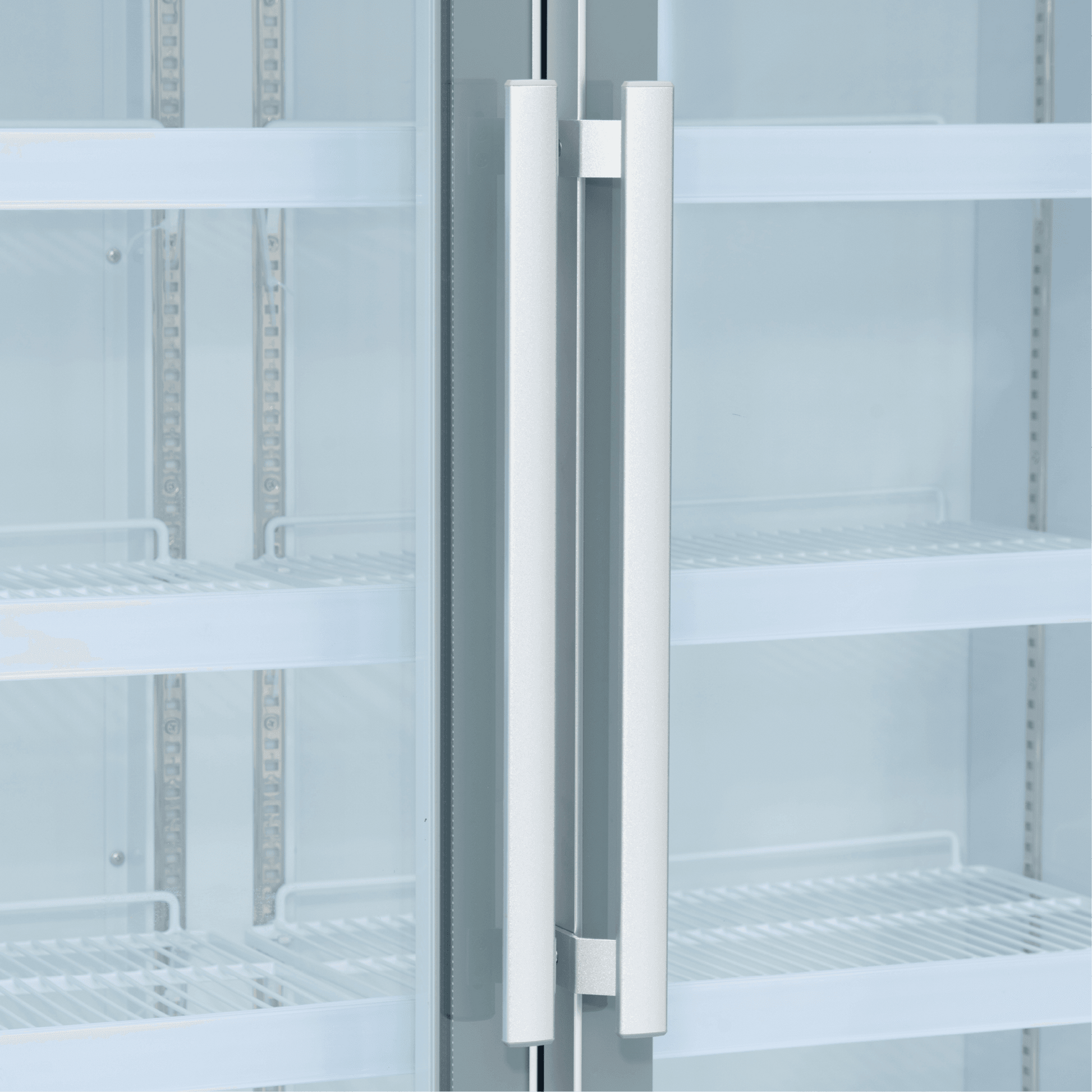 White upright display refrigerator with two tall glass doors and vertical silver handles.
