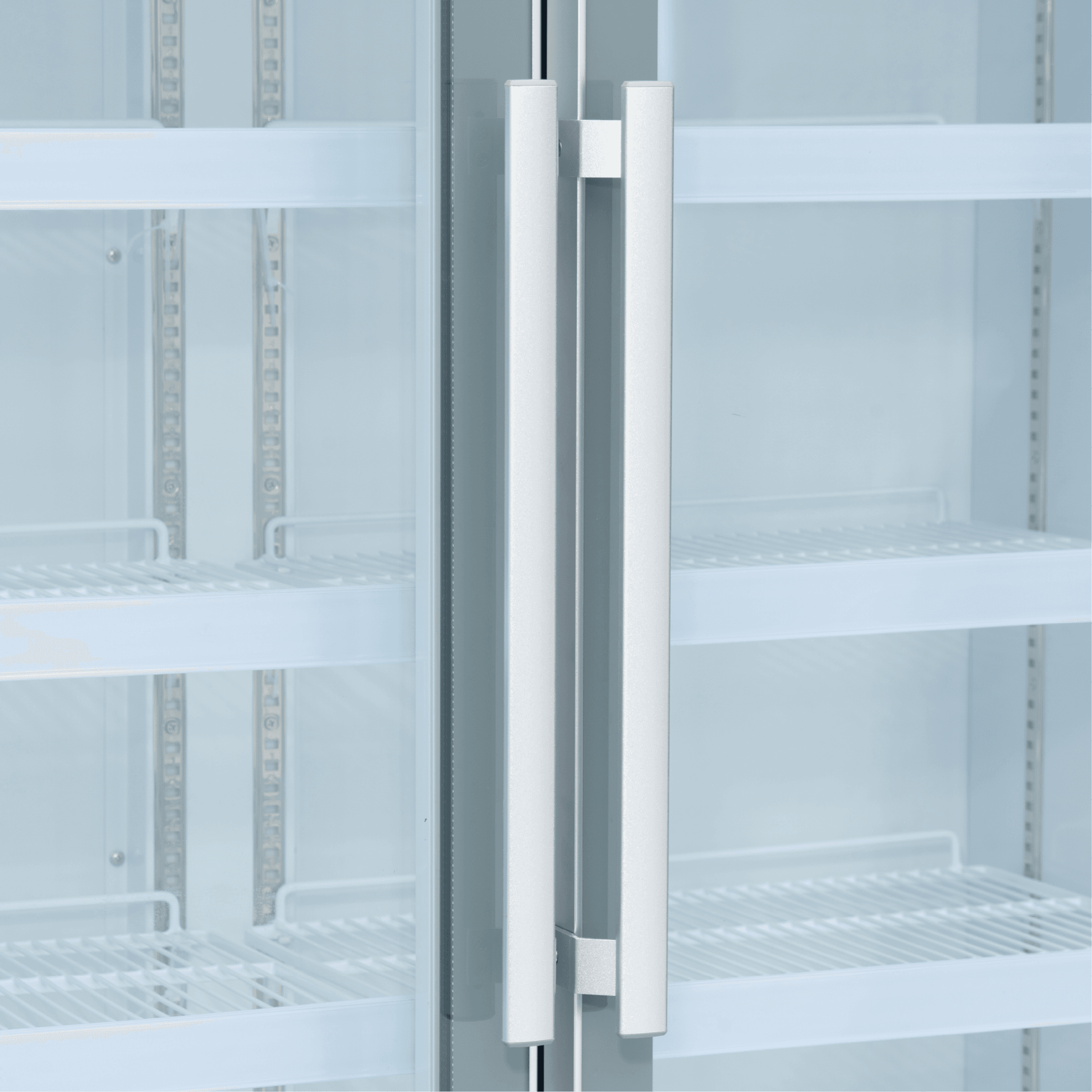 White upright display refrigerator with two tall glass doors and vertical silver handles.