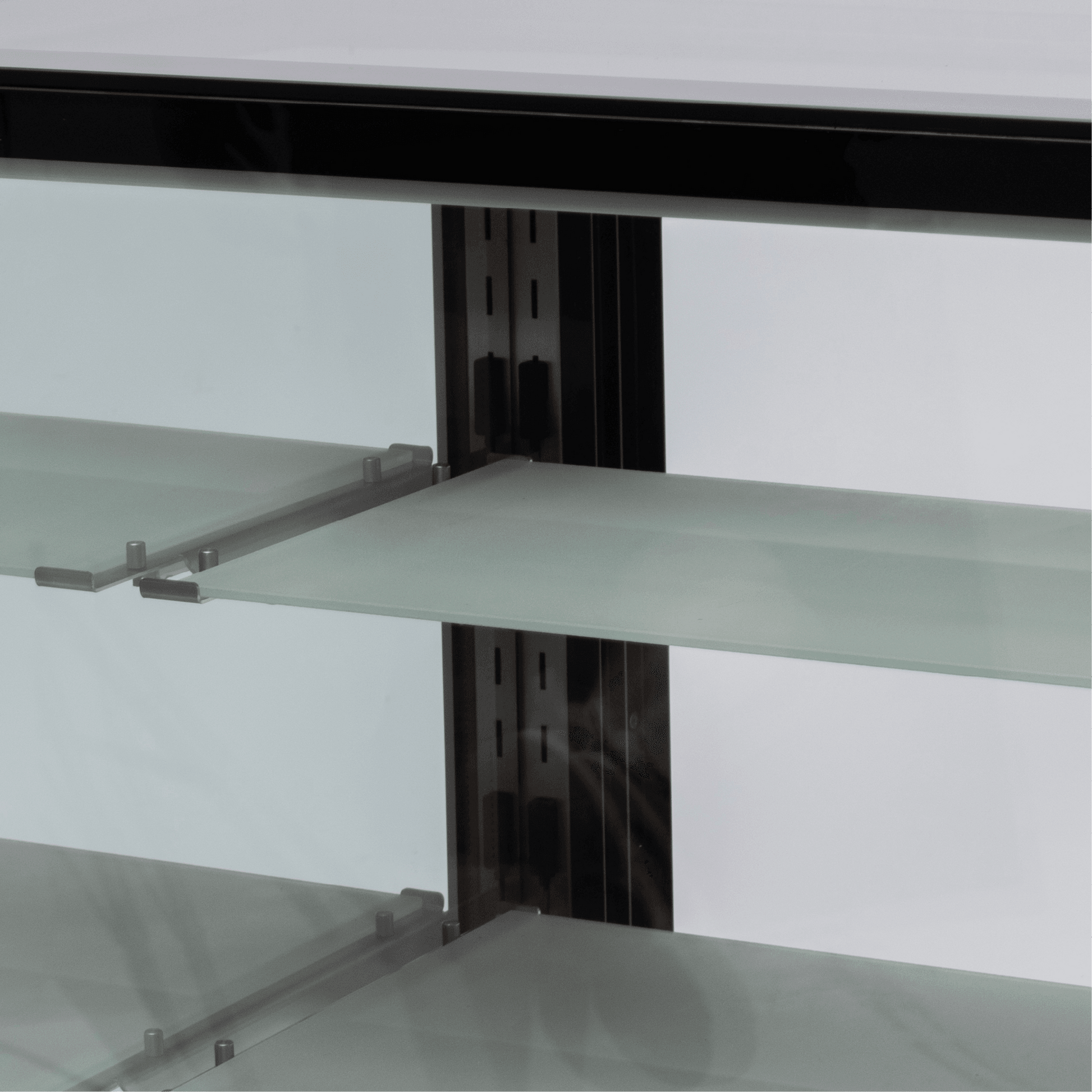 Black stainless steel cake display refrigerator with three frosted glass shelves and mirrored back.