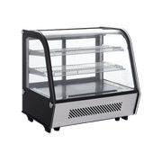 Counter top curved glass cake display refrigerator with three stainless steel shelves and black frame.