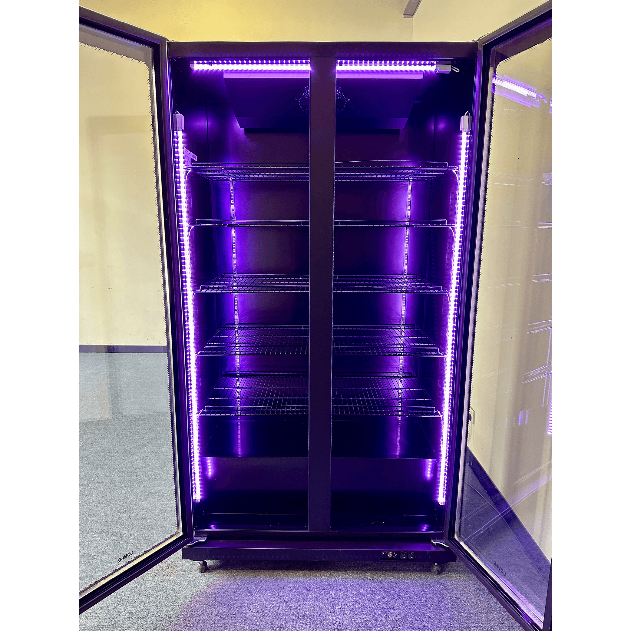 Black three-door upright display fridge with glass doors and purple interior LED lighting.