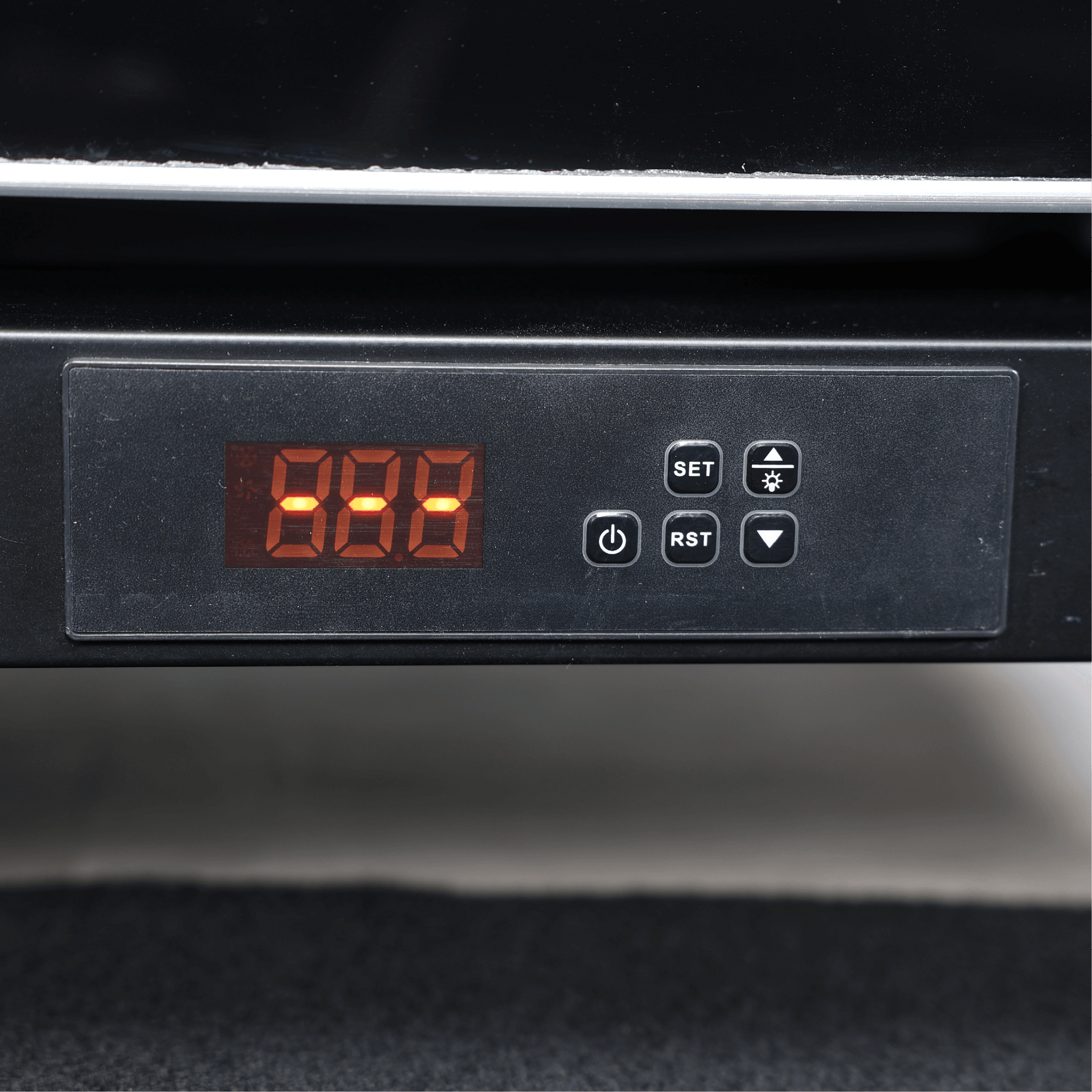 Digital control panel with red LED display and black buttons on black glass door refrigerator.