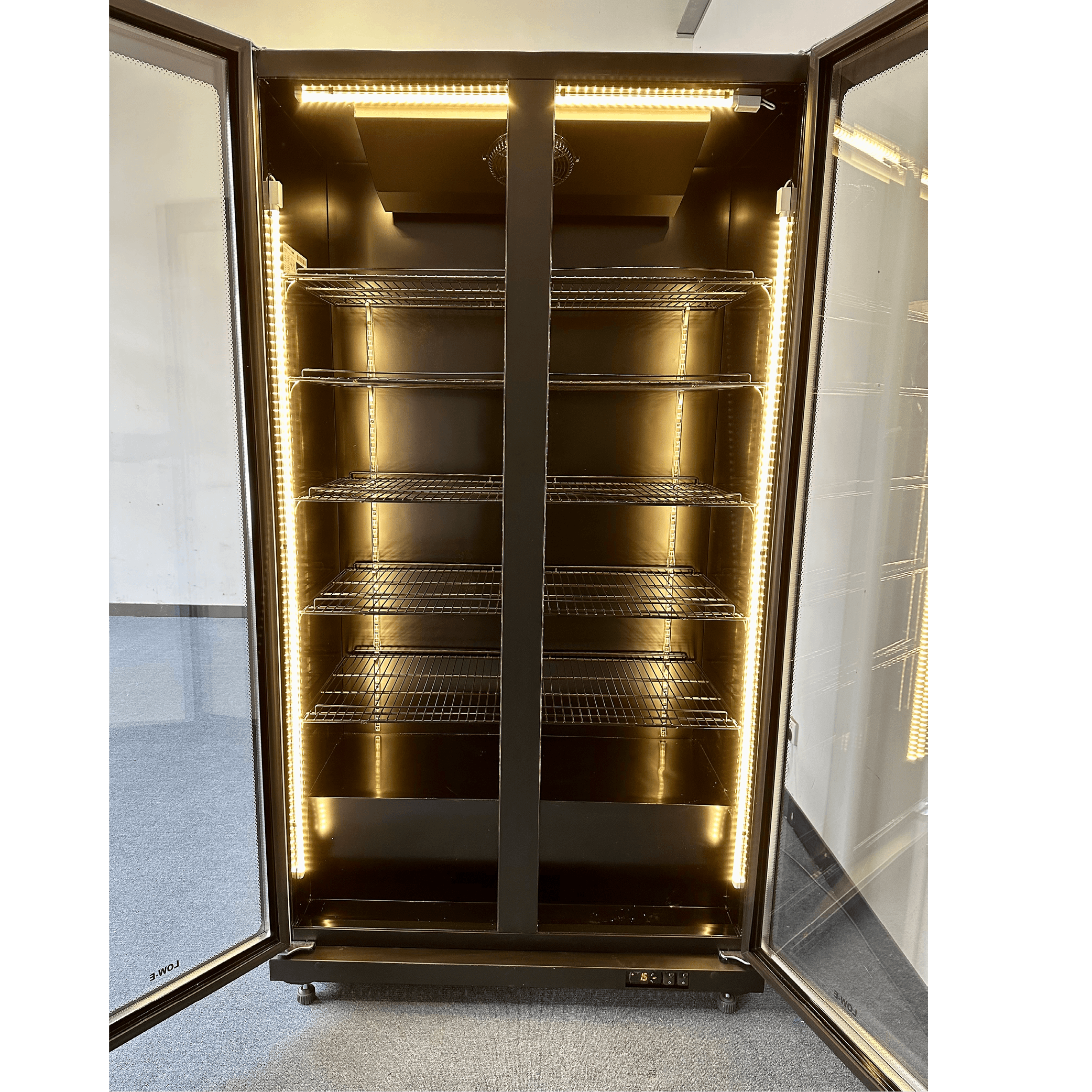 Black upright glass door display refrigerator with interior LED lighting and multiple adjustable shelves.