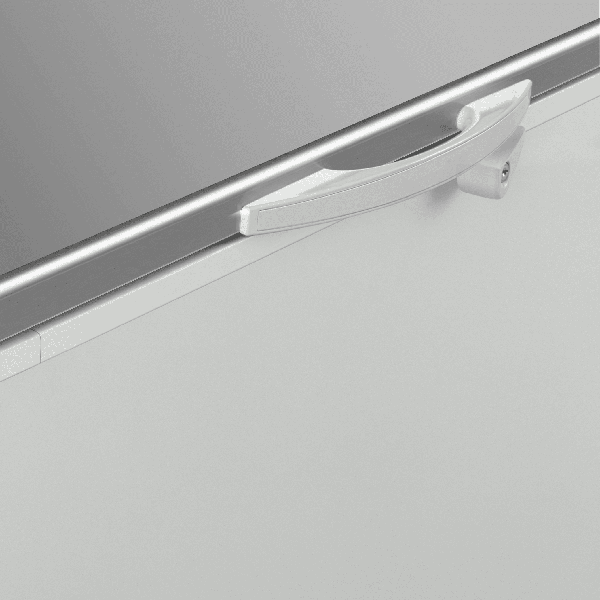 White painted steel handle on a stainless steel top panel of a chest freezer door.