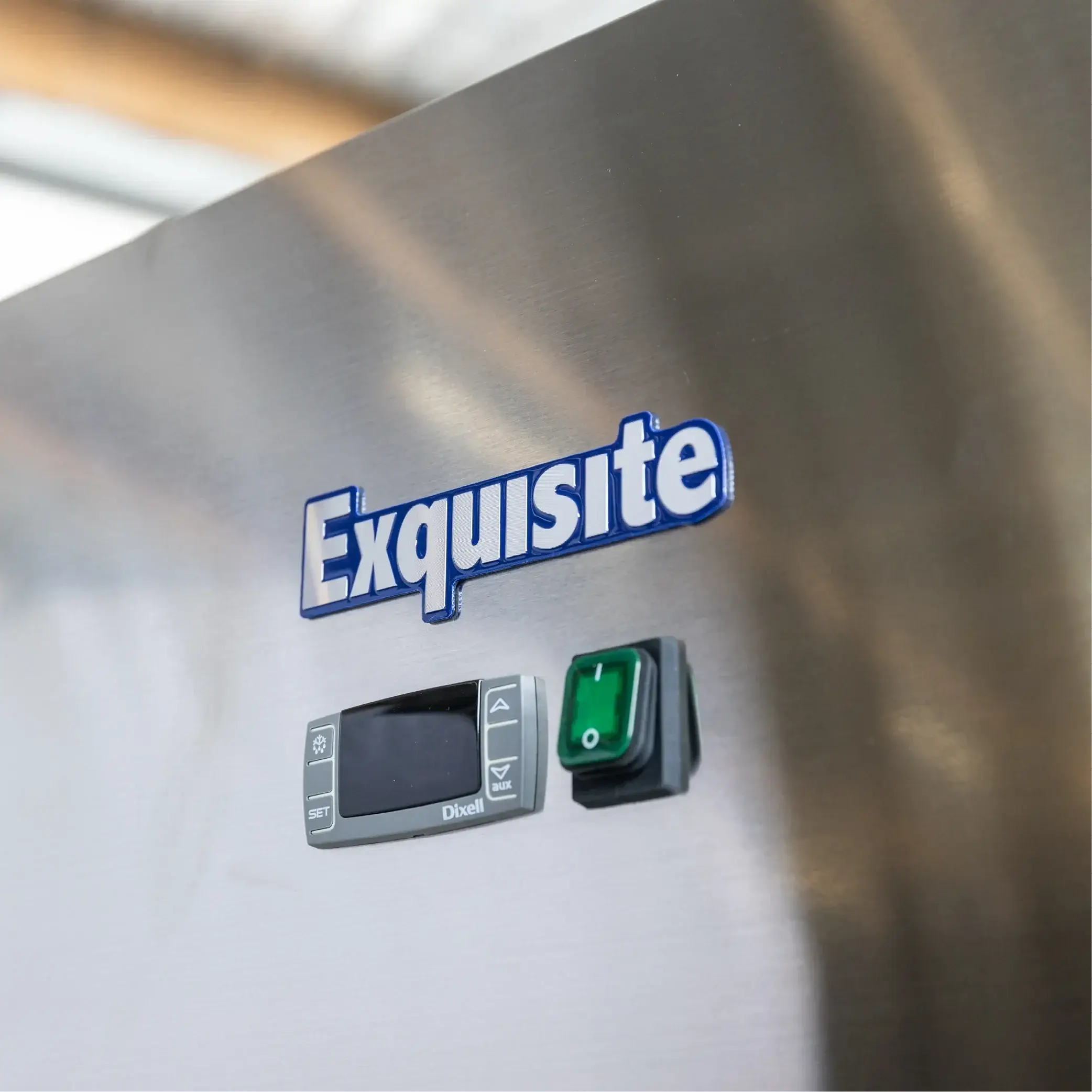Stainless steel freezer door with Exquisite logo, digital control panel, and green power switch.