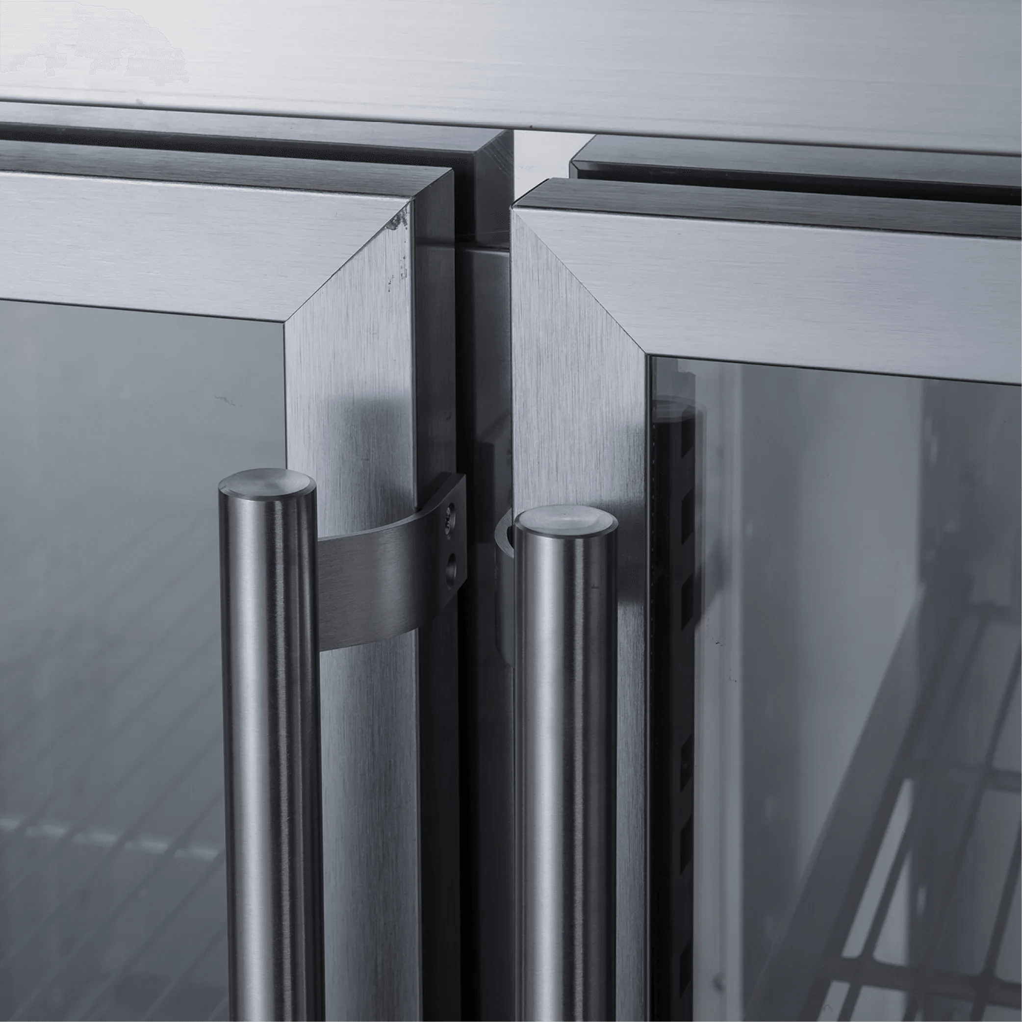 Stainless steel underbench refrigerator with three glass doors and vertical tubular handles.