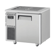 Stainless steel Turbo Air underbench salad prep fridge with one solid door and refrigerated toppings pans on top.
