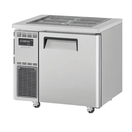 Stainless steel Turbo Air underbench salad prep fridge with one solid door and refrigerated toppings pans on top.