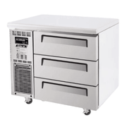 Stainless steel 3-drawer underbench freezer with ventilation panel and caster wheels.