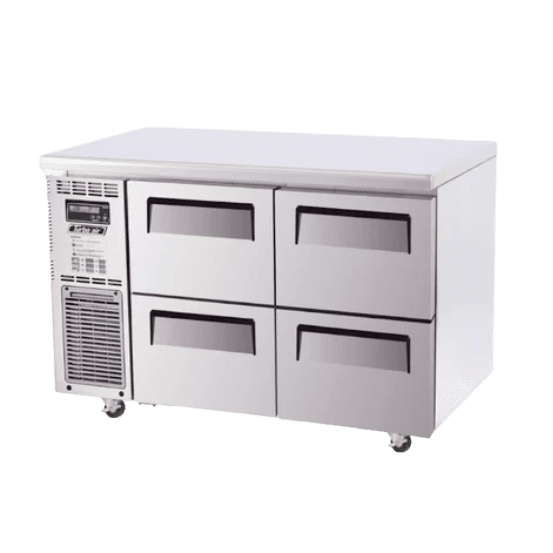 Stainless steel Turbo Air underbench fridge with four pull-out drawers and ventilation panel on left side.