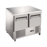 Stainless steel underbench refrigerator with two solid doors and ventilation grilles at the base.