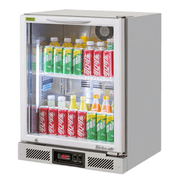 Compact stainless steel back bar fridge with single glass door and LED-lit shelves displaying assorted soft drinks.